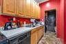 Kitchen with crown molding, black dishwasher, and sink
