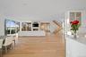Living room featuring a wall of windows and light wood-type flooring