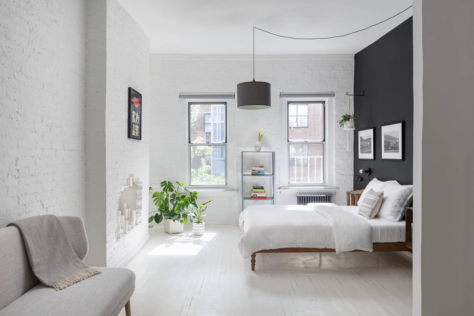 Sun drenched with light from the six windows that wrap this top floor studio one bedroom East Village loft.