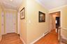 Corridor featuring crown molding, light hardwood / wood-style flooring, and baseboard heating