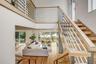 Staircase with hardwood / wood-style floors and a towering ceiling