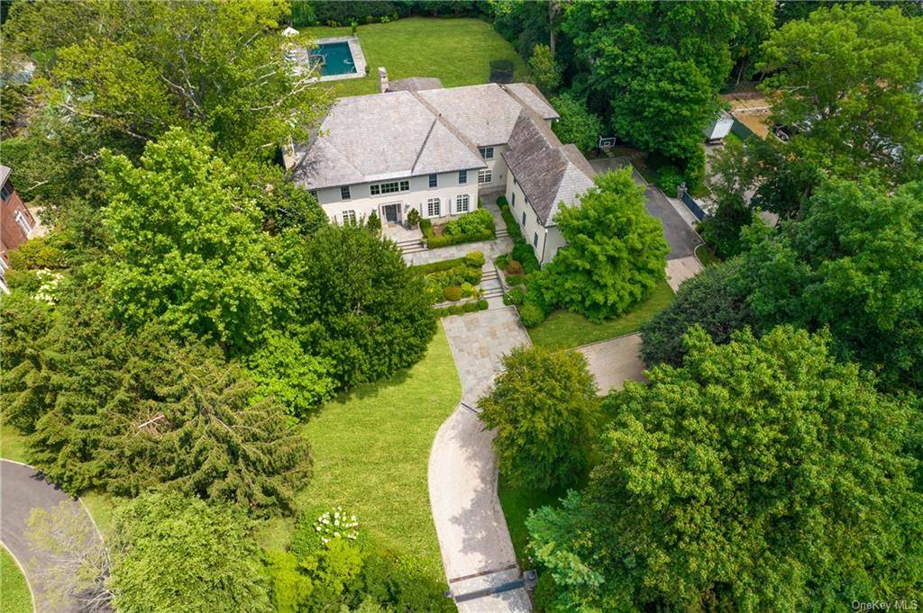 Spectacular Scarsdale living awaits in this work of art colonial featuring expansive designer interiors and over an acre of landscaped grounds in Murray Hill's estate section.