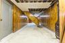 Finished basement featuring wood walls and stairs