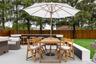 Wooden deck with a fenced backyard and outdoor dining area