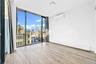 Unfurnished room with expansive windows, a baseboard radiator, wood tiled floors, and a wall mounted air conditioner