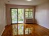 Empty room with radiator heating unit and wood finished floors