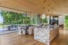 Open concept living with rich natural materials carrying from the inside to outside seamlessly.