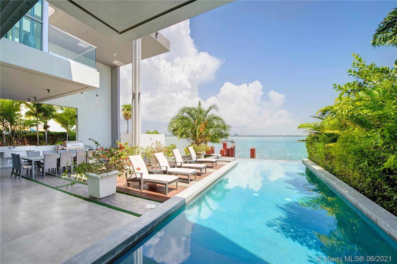 Luxury modern waterfront home on Venetian Islands with soaring ceilings and walls of glass taking in the magnificent wide bay views in every direction !