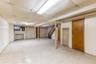 Finished basement with stairs, a drop ceiling, and tile patterned floors