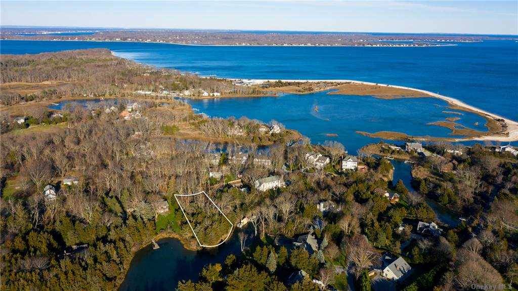 Beautiful 0. 53 acre waterfront lot with PERMITS PENDING and 126ft feet of water frontage w access to Peconic Bay.