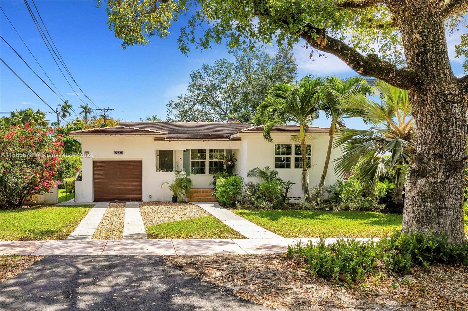 Nestled in Coral Gables, this charming 2 bedroom, 2 bathroom home exudes warmth with its timeless wood floors vaulted cathedral ceilings creating an expansive atmosphere.