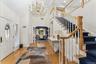 Foyer with a chandelier, arched walkways, light wood-style floors, and high vaulted ceiling
