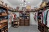 Large custom primary closet with built-ins and excellent storage.