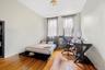 Bedroom featuring wood-type flooring and an office area
