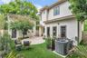Backyard oasis- easy maintenance turf, Travertine pavers, covered porch and new white vinyl fence