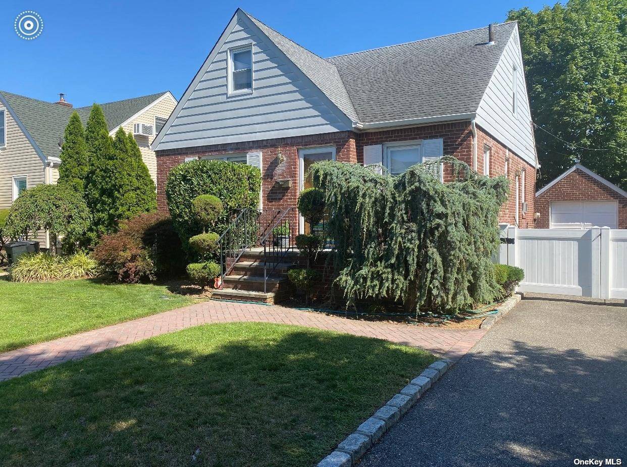Lovely Mid Block Brick Cape located in Great Neck School District.