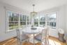Dining space with a chandelier, baseboards, healthy amount of natural light, and light wood-style floors