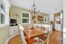 Dining room featuring light wood finished floors, a baseboard radiator, a chandelier, and recessed lighting