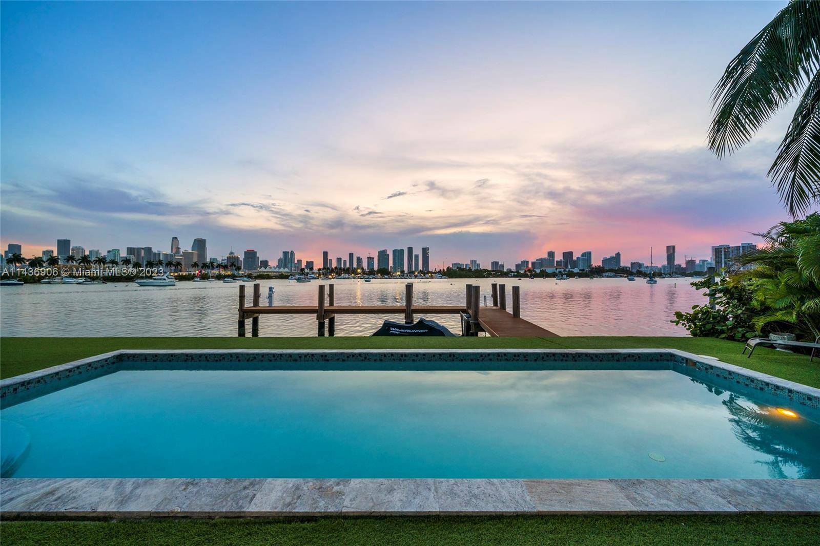 2 story waterfront home on the coveted Western tip of Palm Island offering stunning unobstructed views of the Miami Skyline Biscayne Bay.
