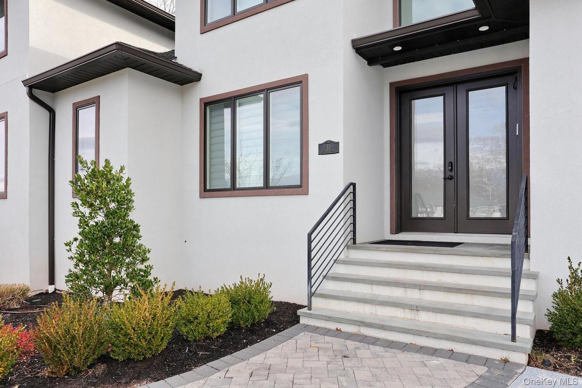 Doorway to property featuring stucco siding and french doors