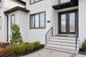Doorway to property featuring stucco siding and french doors