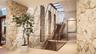 Stone-lined vestibule with floating steel, wood and glass staircase