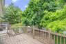 Expansive outdoor deck with wood-finish flooring and full railing system