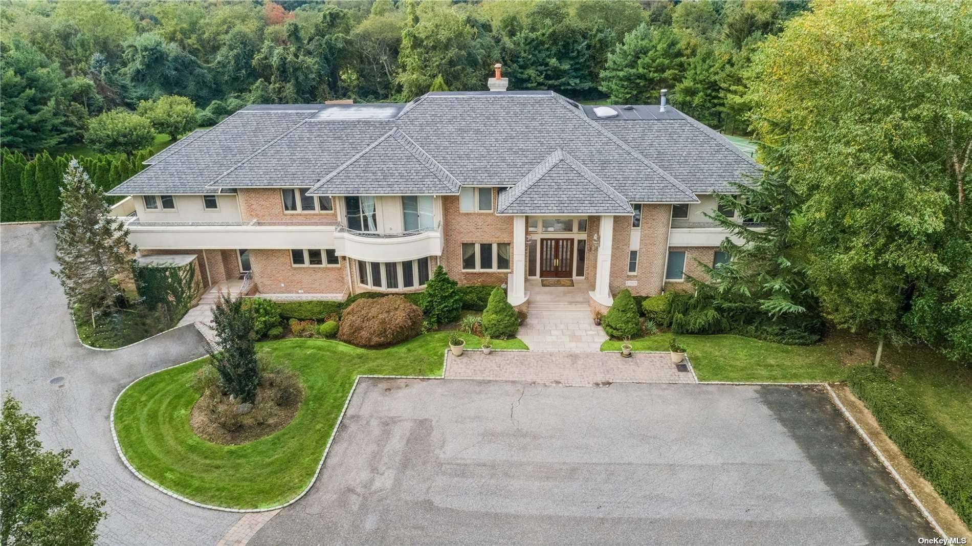 Welcome to this luxurious 10, 000 sq ft custom, brick colonial nestled on over four acres of beautifully landscaped property on the Gold Coast of Long Island.