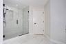 Bathroom with marble finish flooring, a marble finish shower, and recessed lighting
