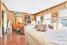 Bedroom featuring crown molding and wood finished floors