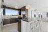 Kitchen with a breakfast bar area, modern cabinets, dark brown cabinetry, and a peninsula
