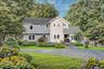 VIRTUAL RENDERING - View of front of property featuring a front lawn, roof with shingles, and a chimney