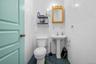 Half bathroom featuring tile walls and dark tile patterned floors