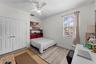Secondary bedroom with generous closet space and ceiling fan.
