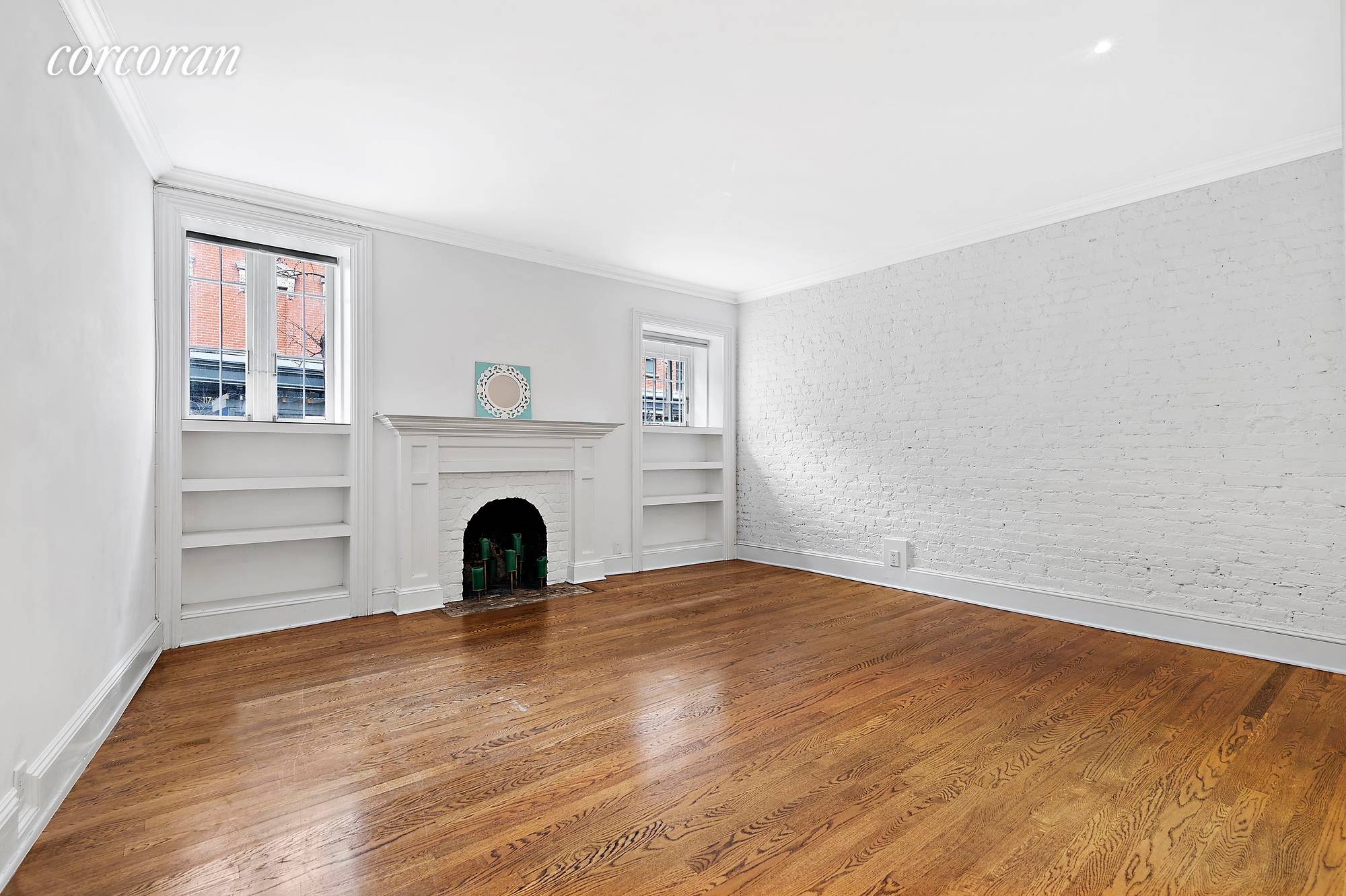 Adorable west village 1 bedroom with 2 decorative fireplaces, exposed brick, a renovated bathroom, hardwood floors located in a historic co op.