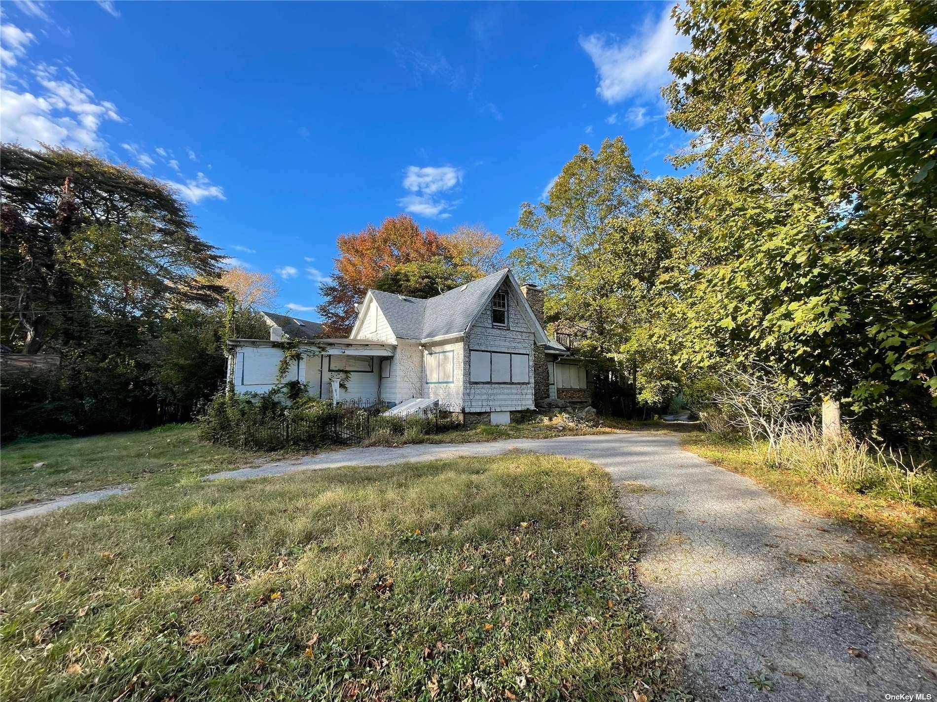 Horton's Point, Southold North Fork solid acre by beach with existing 1910 house sold in as is condition with caretaker cottage and horse stable.