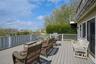 Wooden deck featuring area for grilling