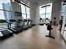 Exercise room with a high ceiling and floor to ceiling windows