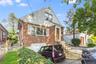 Bungalow-style home featuring brick siding and an attached garage