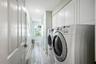 Ample storage in laundry room off garage