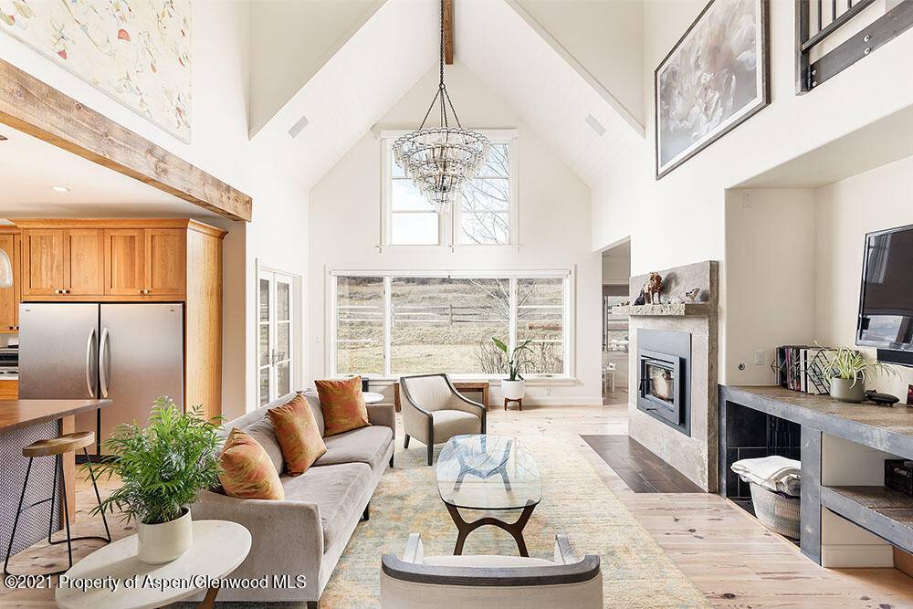 Enjoy this tranquil getaway in Old Snowmass with expansive mountain views, approximately an acre of fenced yard including a private pond and meandering stream.