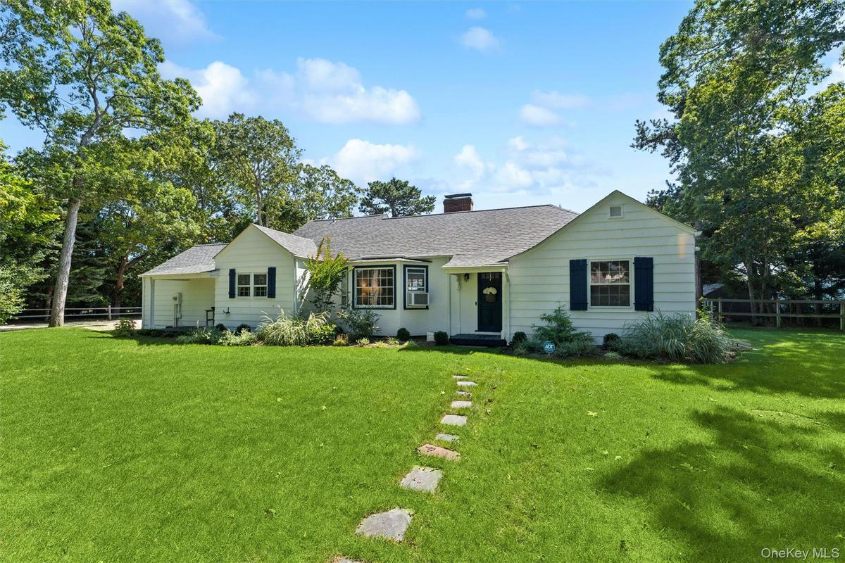 Ranch-style home with a chimney, a shingled roof, and cooling unit