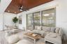 Triple sliding glass doors open to a covered and screened lanai. Virtually Staged.