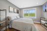 Bedroom with wood finished floors and recessed lighting
