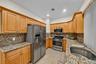 The honey glazed cabinets with crown molding show off the granite counters.