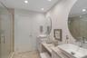 Full bath with a stall shower, double vanity, and recessed lighting