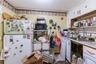white cabinetry, light countertops, and black microwave