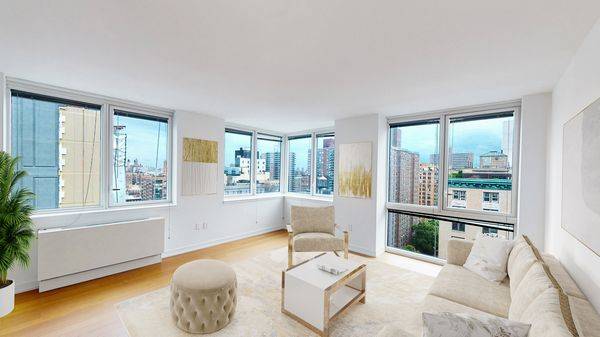 Sprawling 2 bedroom with wrap around corner living room windows featuring dramatic panoramic views of Broadway and uptown NYC.