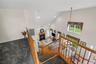 Stairs with high vaulted ceiling, a glass covered fireplace, recessed lighting, and carpet flooring