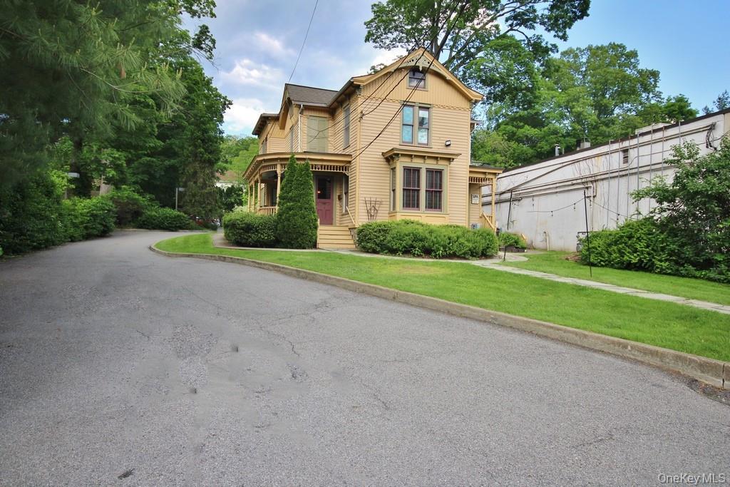 Victorian-style house featuring a front lawn